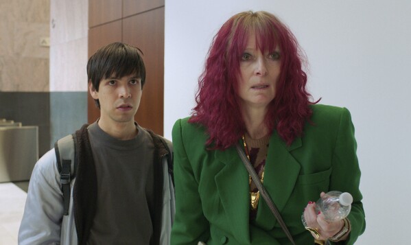This image released by A24 Films shows Julio Torres, left, and Tilda Swinton in a scene from "Problemista." (A24 via AP)