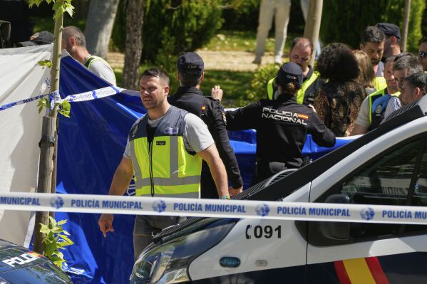 Members of the judicial police at the scene after an adviser to former Ukrainian president Viktor Yanukovych was shot, outside a school in Madrid, Spain, Wednesday, May 21, 2025. (AP Photo/Paul White)