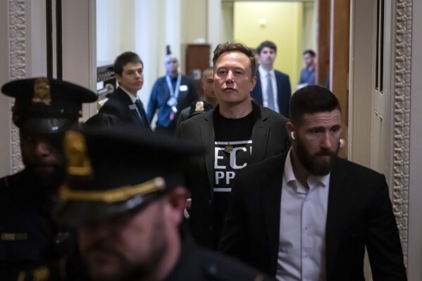Elon Musk leaves after meeting with Senate Republicans, at the Capitol in Washington, Wednesday, March 5, 2025. (AP Photo/Ben Curtis)