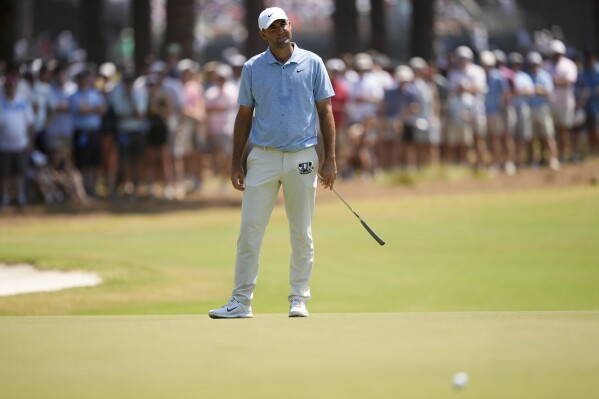 Scottie Scheffler reacts after missing a putt on the seventh hole during the third round of the U.S. Open golf tournament Saturday, June 15, 2024, in Pinehurst, N.C. (AP Photo/Matt York)