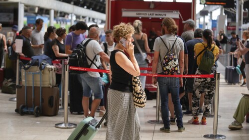 Passengers queue at a Trenitalia ticket office at Milan central station during a national train strike, Thursday, July 13, 2023. Trenitalia and Italo train workers are on strike to demand better working conditions and training. in Milan, Italy, Thursday, July 13, 2023. (AP Photo/Luca Bruno)