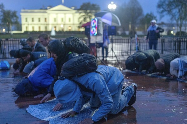 Protesters pray during a demonstration in support of Palestinians, Tuesday, April 2, 2024, at Lafayette Park across from the White House in Washington,. (AP Photo/Jose Luis Magana)