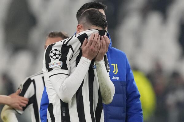 Juventus' Mattia De Sciglio covers his face at the end of the Champions League, round of 16, second leg soccer match between Juventus and Villarreal at the Allianz stadium in Turin, Italy, Wednesday, March 16, 2022. Villareal won 3-0. (AP Photo/Antonio Calanni)