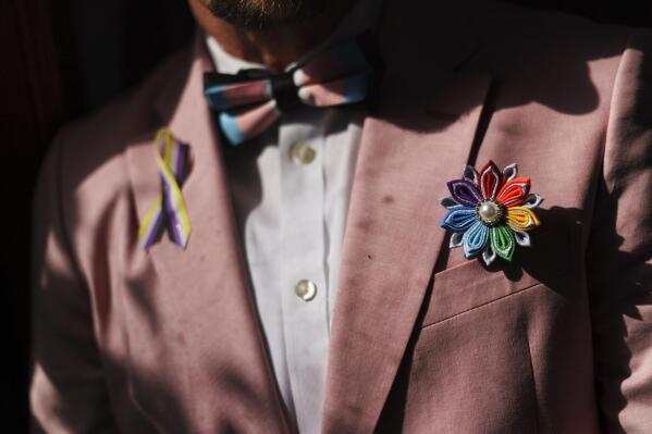 A rainbow flower sits in the jacket pocket of Scout, a transgender man who uses one name, at his home in Providence, R.I., Wednesday, June 8, 2022. The U.S. Census Bureau is requesting millions of dollars to study how best to ask about sexual orientation and gender identity. The results could provide much better data about the LGBTQ population nationwide at a time when views about sexual orientation and gender identity are evolving. (AP Photo/David Goldman)
