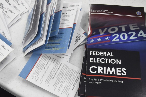 Educational materials provided by the Committee of Safe and Secure Elections are pictured at a conference with local election and law enforcement officials Wednesday, April 10, 2024, in Traverse City, Mich. A top concern for local election workers throughout the country this year is their own safety. The committee, formed after the 2020 presidential election, is traveling the country helping them prepare for what could lie ahead and making sure they are connected to local law enforcement. (AP Photo/John L. Russell)