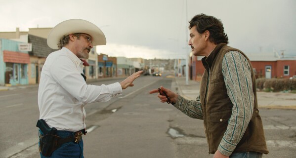 Joaquin Phoenix, left, and Pedro Pascal in a scene from Ari Aster's "Eddington." (A24 via AP)