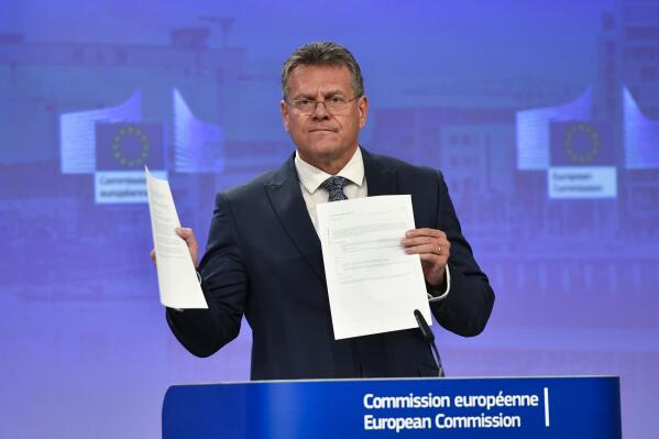 European Commissioner for Inter-institutional Relations and Foresight Maros Sefcovic holds up documents as he speaks during a media conference at EU headquarters in Brussels, Wednesday, June 15, 2022. Britain's government on Monday proposed new legislation that would unilaterally rewrite post-Brexit trade rules for Northern Ireland, despite opposition from some U.K. lawmakers and EU officials who say the move violates international law. (AP Photo/Geert Vanden Wijngaert)