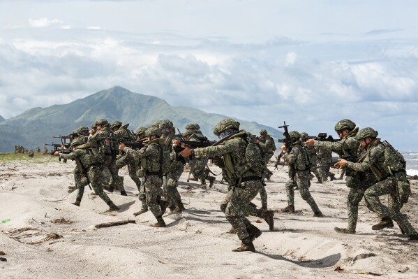 In this photo released by Australian Department of Defense via Australian Embassy in the Philippines, Armed Forces of the Philippines soldiers are partaking in a large-scale combined amphibious assault exercise on Friday, Aug. 25, 2023, at a naval base in San Antonio, Zambales, Philippines. The Philippines and Australia, while also backed by the United States Marine Corps, are holding a bilateral amphibious training called "Exercise Alon 2023," coined from Tagalog word meaning "wave," which is aimed at enhancing interoperability and preparedness to respond to security challenges in the Indo-Pacific region. (Riley Blennerhassett/Australian Department of Defense via AP)