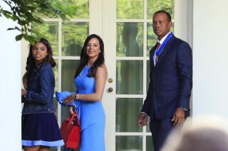 FILE - Tiger Woods, right, with his daughter Sam Alexis Woods, left, and his girlfriend Erica Herman, center, walk along the Colonnade following a ceremony where President Donald Trump awarded the Presidential Medal of Freedom to Tiger Woods at the White House in Washington, on May 6, 2019. Herman wants to nullify a nondisclosure agreement following a six-year relationship with the professional golfer, according to court records Monday, March 6, 2023. (AP Photo/Manuel Balce Ceneta, File)