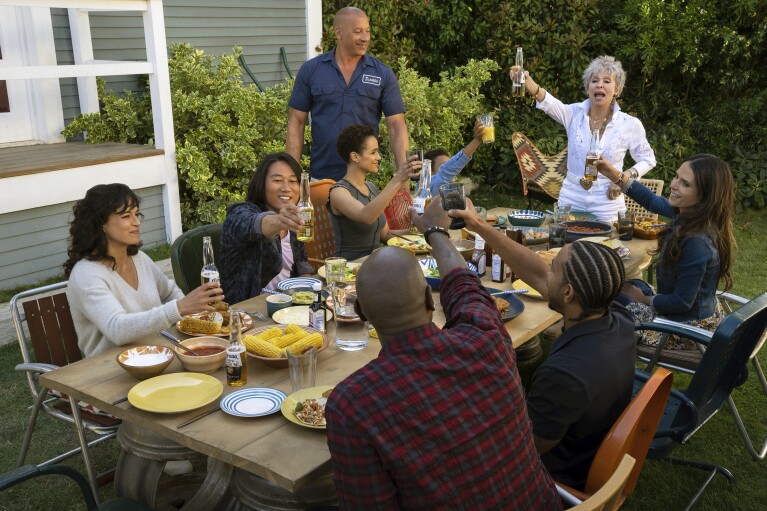 This image released by Universal Pictures shows, clockwise from left, Michelle Rodriguez, Sung Kang, Nathalie Emmanuel, Vin Diesel, Leo Abelo Perry, Rita Morena, Jordana Brewster, Ludacris and Tyrese Gibson in a scene from "Fast X." (Peter Mountain/Universal Pictures via AP)
