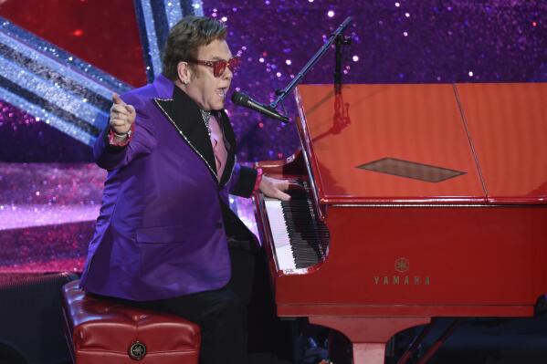 FILE - In this Feb. 9, 2020, file photo, Elton John performs "(I'm Gonna) Love Me Again," nominated for the award for best original song, from "Rocketman" at the Oscars in Los Angeles. John is opening up his vault and releasing an expansive collection of rarely heard and unreleased tracks. John announced Thursday, Sept. 17, 2020, that the eight-CD collection, “Elton: Jewel Box," will be released Nov. 13. The collection includes “Sing Me No Sad Songs,” an unreleased studio demo from 1969. (AP Photo/Chris Pizzello, File)