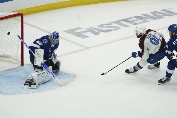 Colorado Avalanche center Nazem Kadri (91) shoots the puck past Tampa Bay Lightning goaltender Andrei Vasilevskiy (88) for a goal during overtime of Game 4 of the NHL hockey Stanley Cup Finals on Wednesday, June 22, 2022, in Tampa, Fla. (AP Photo/John Bazemore)