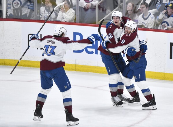 Colorado Avalanche Zach Parise (9) celebrates his goal against the Winnipeg Jets with Josh Manson (42) and Yakov Trenin (73) during the second period in Game 2 of an NHL hockey Stanley Cup first-round playoff series Tuesday, April 23, 2024, in Winnipeg, Manitoba. (Fred Greenslade/The Canadian Press via AP)