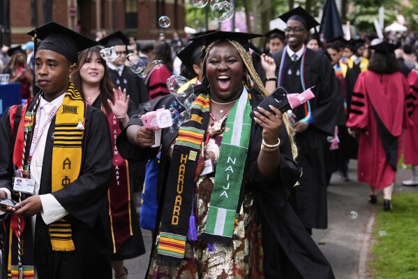 Students walk through Harvard Yard during commencement ceremonies at Harvard University, Thursday, May 29, 2025, in Cambridge, Mass. (AP Photo/Charles Krupa)