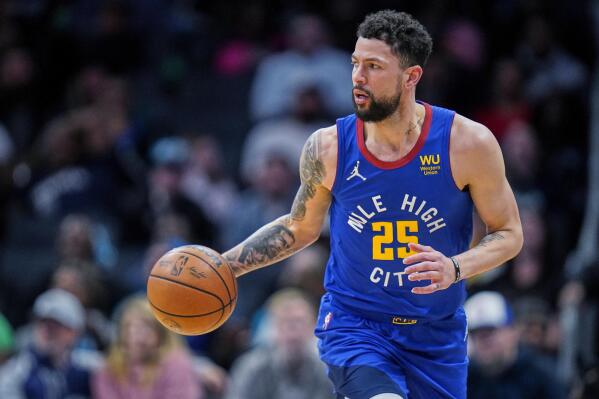 FILE - Denver Nuggets guard Austin Rivers brings the ball up during the team's NBA basketball game against the Charlotte Hornets on March 28, 2022, in Charlotte, N.C. The Minnesota Timberwolves have signed Rivers, the team announced Thursday, July 21. (AP Photo/Rusty Jones, File)