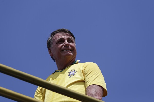 Former President Jair Bolsonaro attends a rally on Copacabana Beach in support of a proposed bill to grant amnesty to those arrested for storming government buildings in an alleged coup attempt in 2023, in Rio de Janeiro, Sunday, March 16, 2025. (AP Photo/Bruna Prado)