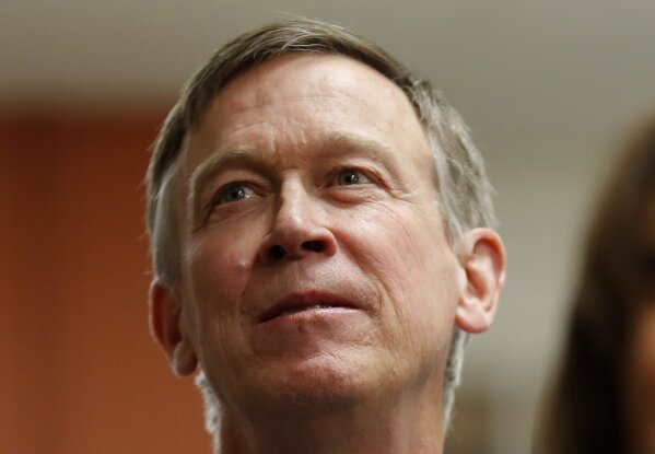 
              FILE - In this Feb. 23, 2019, file photo, former Colorado Gov. John Hickenlooper, left, waits to speak at the Story County Democrats' annual soup supper fundraiser in Ames, Iowa. Hic...