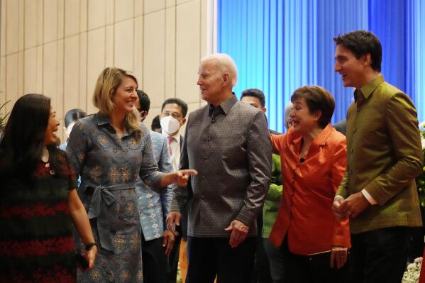 Flanked by Canada's Prime Minister Justin Trudeau, right, and International Monetary Fund Kristalina Georgieva, second right, U.S. President Joe Biden speaks with Canada's Foreign Minister Melanie Holy at the Association of Southeast Asian Nations (ASEAN) gala dinner, Saturday, Nov. 12, 2022, in Phnom Penh, Cambodia. (AP Photo/Alex Brandon)
