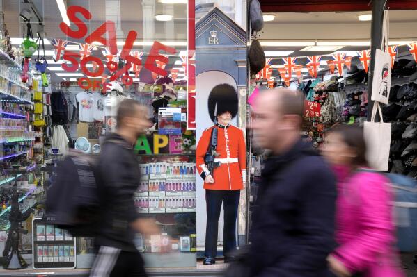 Pedestrians pass a souvenir shop on Oxford Street in London, Friday, Nov. 11, 2022. The UK GDP is down 0.2% in the three months to Sept. and it is expected to be in recession by the end of 2022. (AP Photo/Kirsty Wigglesworth)