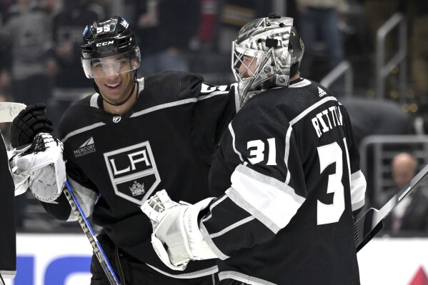 Los Angeles Kings right wing Quinton Byfield, left, congratulates goaltender David Rittich (31) after after the team's win over the New York Rangers in an NHL hockey game Saturday, Jan. 20, 2024, in Los Angeles. (AP Photo/Jayne-Kamin-Oncea)