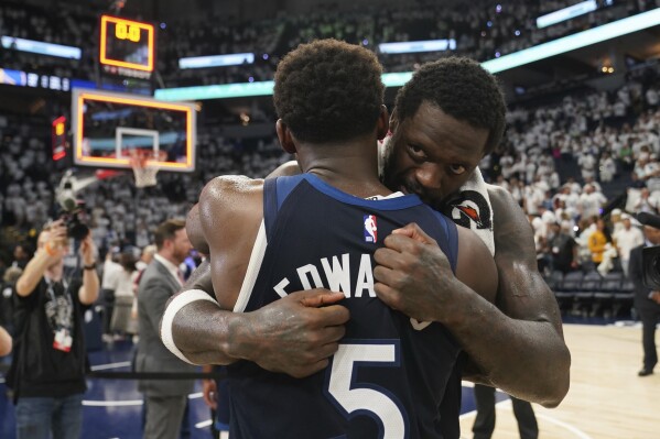 Minnesota Timberwolves forward Julius Randle (30) and Minnesota Timberwolves guard Anthony Edwards (5) hug after Game 5 of an NBA basketball second-round playoff series against the Golden State Warriors, Thursday, May 15, 2025, in Minneapolis. (AP Photo/Abbie Parr)