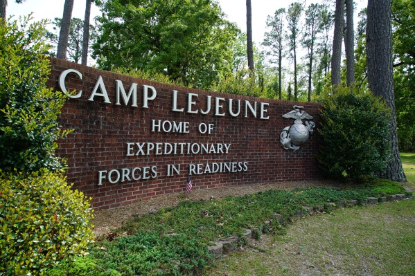 FILE - Signage stands on the main gate to Camp Lejeune Marine Base outside Jacksonville, N.C., on April 29, 2022. A Marine was killed in a homicide at Camp Lejeune on Wednesday night, Oct. 18, 2023, and a second Marine was held on suspicion of being involved, the base said. (AP Photo/Allen G. Breed, File)