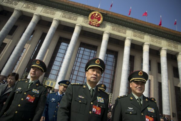 
              In this March 4, 2019, photo, military delegates leave after a meeting one day before the opening session of China's National People's Congress (NPC) at the Great Hall of the People ...