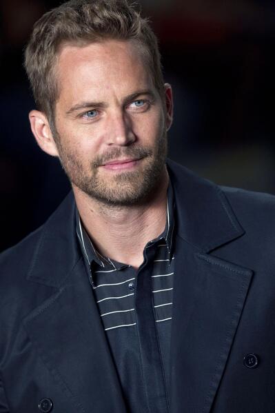 File-This March 21, 2013 file photo shows actor Paul Walker wearing a creation from the Colcci summer collection at Sao Paulo Fashion Week in Sao Paulo, Brazil.  A publicist for actor Walker says the star of the "Fast & Furious" movie series has died in a car crash north of Los Angeles. He was 40. Ame Van Iden says Walker died Saturday, Nov. 30, 2013. No further details were released. (AP Photo/Andre Penner, File)