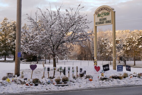 FILE - Snow accumulates outside a restaurant at a makeshift memorial for the victims of last month's mass shooting in Lewiston, Maine, Tuesday, Dec. 5, 2023. The four members of Maine's congressional delegation are calling for an Army investigation into the events leading up to a mass shooting in the state in the wake of meeting with families affected by the killings. (AP Photo/Robert F. Bukaty, File)