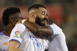 Real Madrid's Karim Benzema celebrates after scoring his side's third goal during a Spanish La Liga soccer match between Mallorca and Real Madrid in Palma de Mallorca, Spain, Monday, March 14, 2022. (AP Photo/Francisco Ubilla)