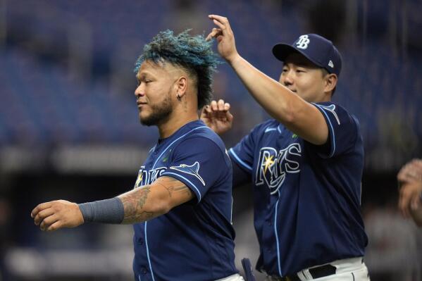 Tampa Bay Rays' Ji-Man Choi, right, touches Harold Ramirez's hair after the Rays defeated the Miami Marlins during a baseball game Wednesday, May 25, 2022, in St. Petersburg, Fla. (AP Photo/Chris O'Meara)