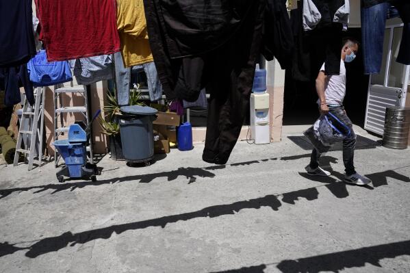 FILE - Juan, of Colombia, hangs his laundry to dry at a shelter for migrants on April 21, 2022, in Tijuana, Mexico. Colombians were stopped at the U.S.-Mexico border more than 15,000 times in March, up nearly 60% from February and nearly 100-fold over last year, according to U.S. Customs and Border Protection figures. AP Photo/Gregory Bull, File)