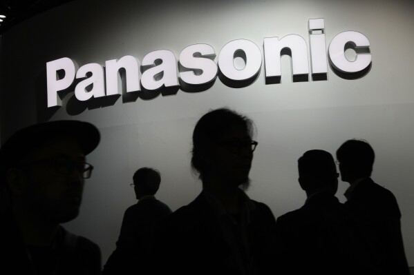 People walk by the Panasonic booth during CES International in Las Vegas on Jan. 9, 2018. (AP Photo/John Locher, File)