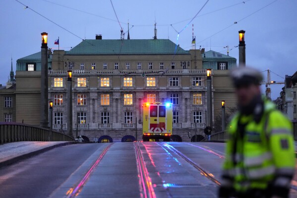 FILE - A police officer guards a street in downtown Prague, Czech Republic, on Dec. 21, 2023. Czech police say a shooting in downtown Prague has killed an unspecified number of people and wounded others. On Friday Jan. 26, 2024, the lower house of Czech Parliament approved an amendment to the country's gun law that tightens conditions to obtain weapons. (AP Photo/Petr David Josek/File)