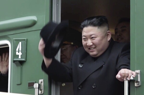 FILE - In this image from video released by Primorsky Regional Administration Press Service, North Korean leader Kim Jong Un waves from his train as he leaves Khasan train station in Primorye region, Russia, Wednesday, April 24, 2019. North Korean leader Kim Jong Un’s possible trip to Russia might be like his first one in 2019, a rattling, 20-hour ride aboard a green-and-yellow armored train that is a quirky symbol of his family’s dynastic leadership. (Primorsky Regional Administration Press Service via AP, File)