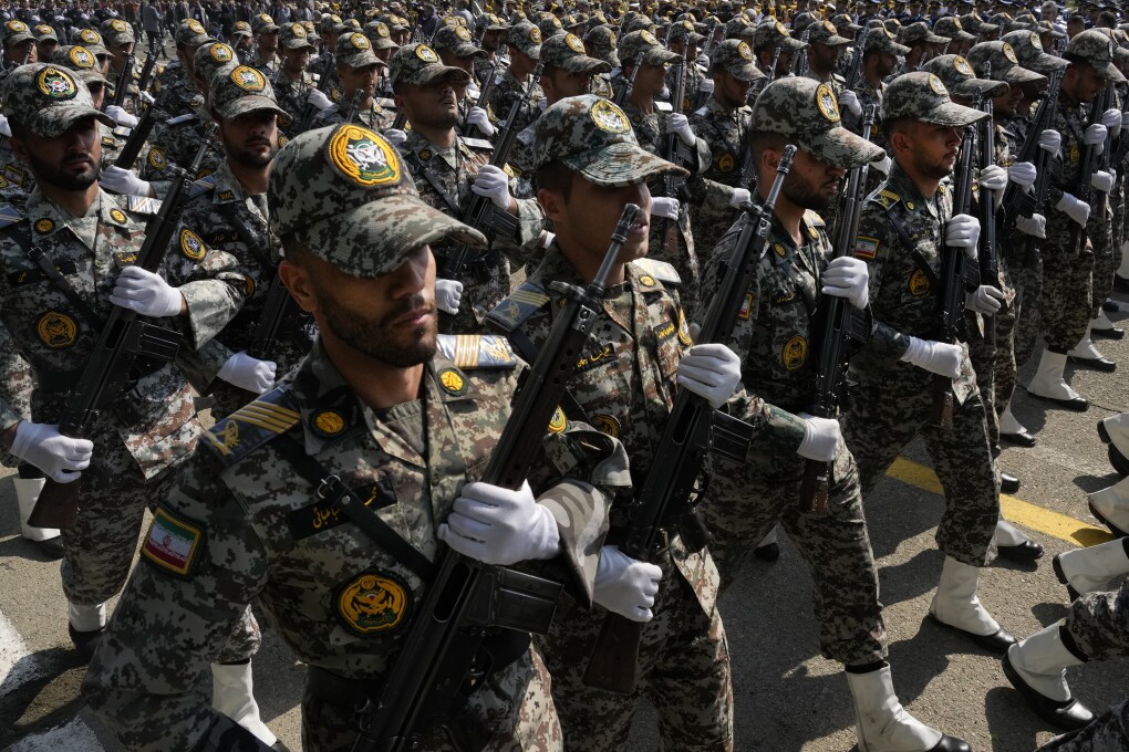 Iranian army members march during Army Day parade at a military base in northern Tehran, Iran, Wednesday, April 17, 2024. In the parade, President Ebrahim Raisi warned that the "tiniest invasion" by Israel would bring a "massive and harsh" response, as the region braces for potential Israeli retaliation after Iran's attack over the weekend. (AP Photo/Vahid Salemi)