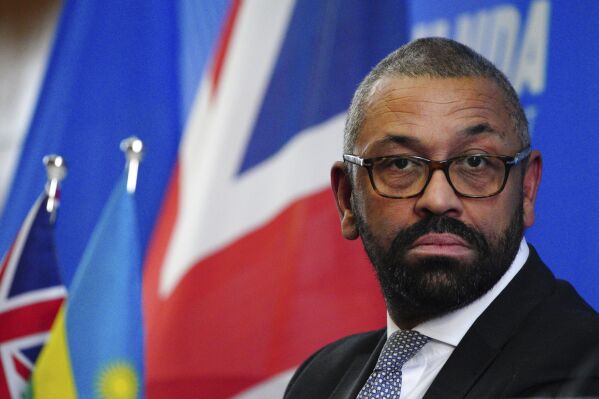 Home Secretary James Cleverly during a press conference with Rwandan Minister of Foreign Affairs Vincent Biruta after the signing of a new treaty in Kigali, Rwanda, Tuesday, Dec. 5, 2023. The treaty will address concerns by the Supreme Court, including assurances that Rwanda will not remove anybody transferred under the partnership to another country. (Ben Birchall/PA Wire via AP)
