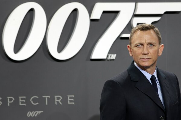 
              FILE - In this Oct. 28, 2015, file photo, actor Daniel Craig poses for the media as he arrives for the German premiere of the James Bond movie 'Spectre' in Berlin, Germany. Producers of the James Bond films say Cary Joji Fukunaga will direct the next instalment in the spy thriller series, replacing Danny Boyle. Michael G. Wilson, Barbara Broccoli and star Daniel Craig announced Thursday, Sept. 20, 2018 that the movie will start filming at London's Pinewood Studios on March 4, and will be released on Feb. 14, 2020.(AP Photo/Michael Sohn, File)
            