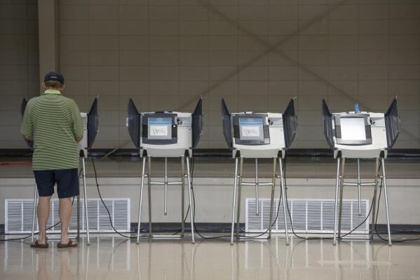 FILE - A voter uses an electronic voting machine to cast a ballot in the Mississippi primary election at a polling location in Jackson County, Miss., on June 7, 2022. Mississippi voters will be able to use their smartphones as voter identification in the November election, marking the first real test of a new statewide program that integrates technology into the voting process. (Hannah Ruhoff/The Sun Herald via AP, File)