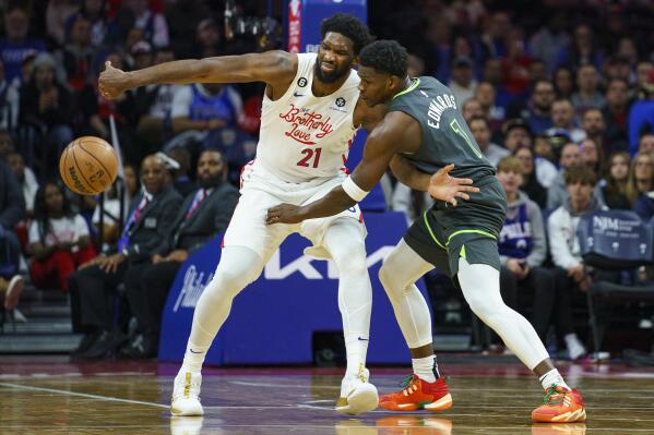 Minnesota Timberwolves' Anthony Edwards, right, knocks the ball away from Philadelphia 76ers' Joel Embiid, left, during the first half of an NBA basketball game, Saturday, Nov. 19, 2022, in Philadelphia. (AP Photo/Chris Szagola)