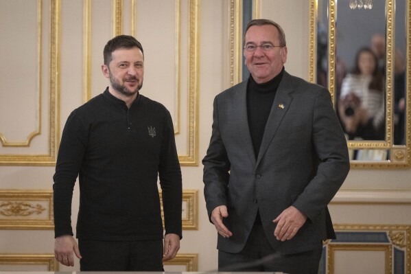 Ukrainian President Volodymyr Zelenskyy, left, and German Defence Minister Boris Pistorius arrive for a meeting in Kyiv, Ukraine, Tuesday, Jan. 14, 2025. (AP Photo/Efrem Lukatsky)