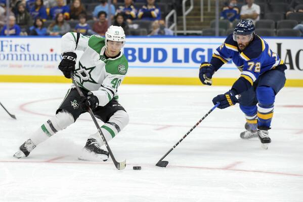 Dallas Stars' Miro Heiskanen (4) and St. Louis Blues' Justin Faulk (72) vie for control of the puck during the third period of a preseason NHL hockey game Monday, Sept. 27, 2021, in St. Louis. (AP Photo/Scott Kane)