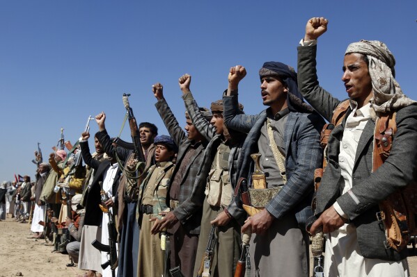 Houthi fighters and tribesmen stage a rally against the U.S. and the U.K. strikes on Houthi-run military sites near Sanaa, Yemen, on Sunday, Jan. 14, 2024. (AP Photo)