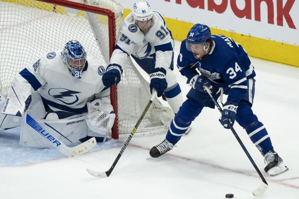 Tampa Bay Lightning center Steven Stamkos (91) and goaltender Andrei Vasilevskiy (88) try to defend against Toronto Maple Leafs center Auston Matthews (34) during the second period of Game 1 of an NHL hockey Stanley Cup first-round playoff series in Toronto, Monday, May 2, 2022. (Frank Gunn/The Canadian Press via AP)