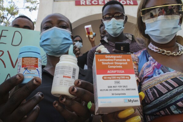 FILE - Protesters hold empty containers of anti-retroviral (ARV) medicines during a demonstration over shortages of ARVs, organized by people living with HIV or AIDS, sex-workers, members of the LGBT community, and their supporters, in the port city of Mombasa, Kenya, Thursday, April 22, 2021. Kenyan authorities issued a warning Wednesday about counterfeit HIV prevention drugs being sold in the country saying "their safety, quality and efficacy cannot be assured." (AP Photo-file)