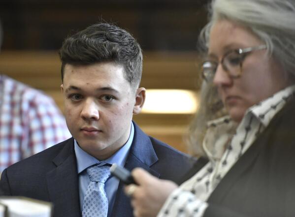 FILE - Kyle Rittenhouse waits for his motion hearing to begin with one of his attorneys, Natalie Wisco, at the Kenosha County Courthouse in Kenosha, Wis., in this Oct. 25, 2021 file photo. Rittenhouse is white. So were the three men he shot during street protests in Kenosha in 2020. But for many people, Rittenhouse's trial will be watched closely as the latest referendum on race and the American judicial system. (Sean Krajacic/The Kenosha News, Pool via AP, File)