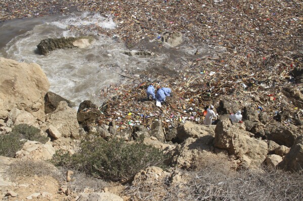 Rescue teams look for flash flood victims in the city of Derna, Libya, Monday, Sept. 18, 2023. Mediterranean storm Daniel caused flooding that overwhelmed two dams, sending a wall of water through the city. More than 10,000 were killed, and another 10,000 are missing. (AP Photo/Yousef Murad)