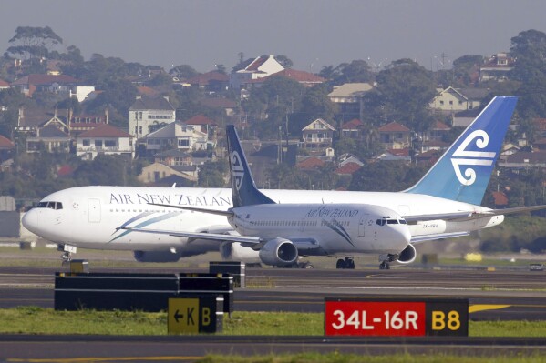 FILE - Two Air New Zealand passenger jets taxi past each other at Sydney Airport on July 13, 2003. A passenger has been fined for urinating in a cup during a delay on deplaning after landing at Sydney Airport. Officials said on Friday, April 5, 2024, in incident after a 3-hour Air New Zealand flight from Auckland occurred in December last year and a Sydney court fined the 53-year-old man 600 Australian dollars for offensive behavior in February. (AP Photo/Mark Baker, File)