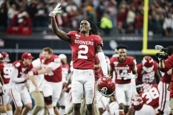 FILE - In this Dec. 7, 2019, file photo, Oklahoma wide receiver CeeDee Lamb (2) celebrates a 30-23 overtime win against Baylor during the Big 12 Championship game, in Arlington, Texas. Lamb was selected to The Associated Press All-America team, Monday, Dec. 16, 2019. (AP Photo/Brandon Wade, File)