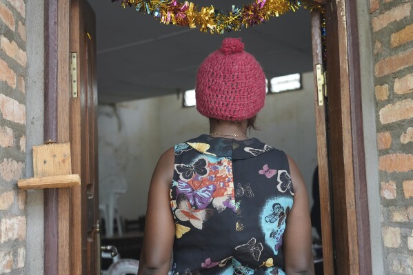 A 39-year-old security guard stands on the doorway at a clinic in Bangui, Central African Republic, Monday, March 11, 2024. She said she was sexually assaulted by a United Nations peacekeeper in November while on the night shift. Sexual assaults and other cases of gender-based violence are rising in Central African Republic. The alleged attackers include everyone from Wagner mercenaries to bandits to United Nations peacekeepers. Reasons include ongoing conflict in one of the world's most volatile countries, a weak legal system and the stigma of speaking up. (AP Photo/Sam Mednick)